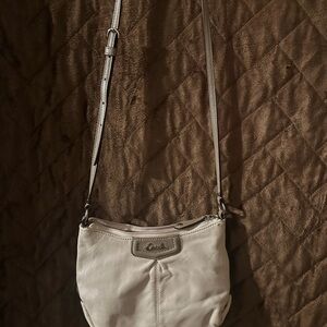 Gently used Coach cream crossbody with rose pink lining, some light pen marks